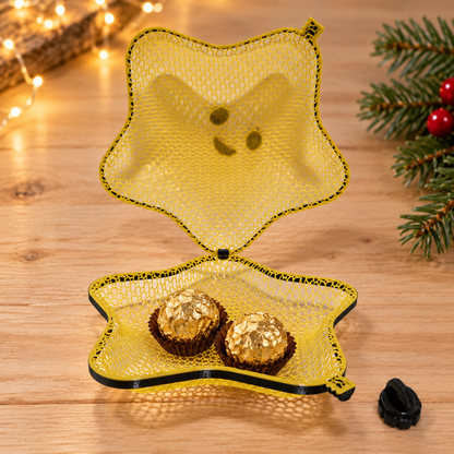 Styled use example of the open mesh star with two foil-wrapped chocolates; chocolates and decorations are not included